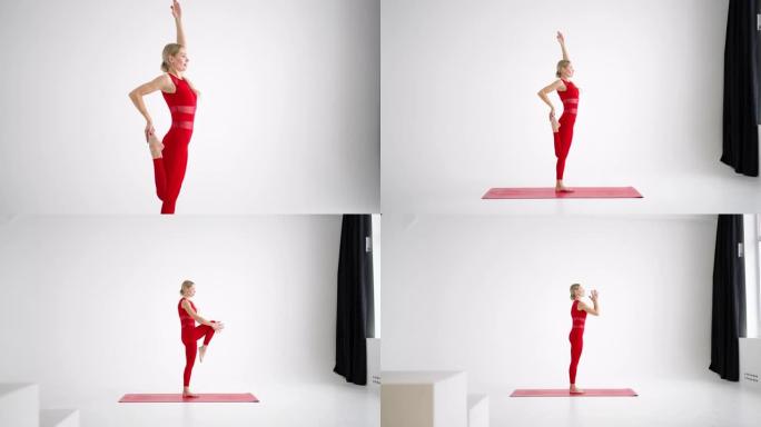 穿着红色运动服的女人看着相机进行训练，并在白色背景上讲述和展示瑜伽或普拉提的练习。瑜伽教练展示家庭课