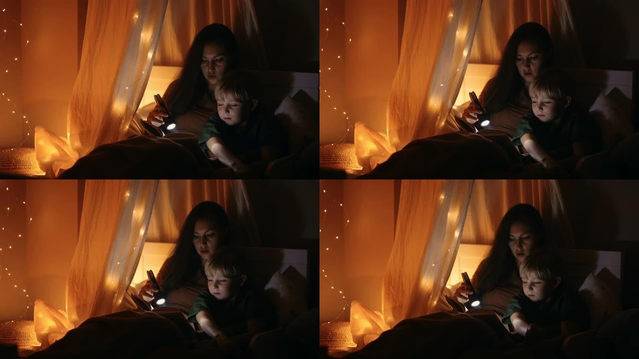 一位母亲和儿子躺在床上，在提着灯笼睡觉前给他读了一个童话。和我儿子一起读一本书，摇篮曲。母亲和儿子在