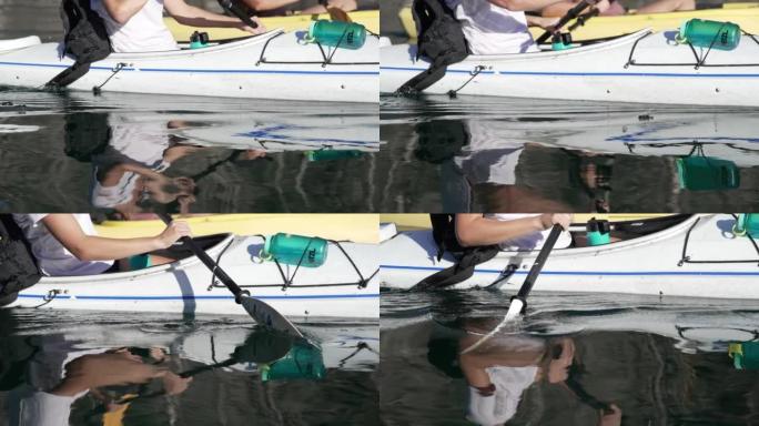 一名女性皮划艇运动员在河里划桨的细节照片