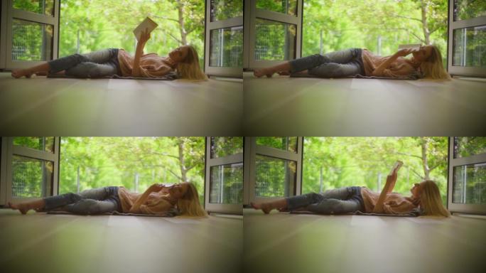 自爱时间。女人躺在开着的窗户旁，享受着书