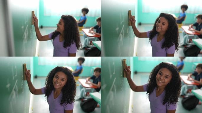 一个女孩在教室里擦黑板的肖像