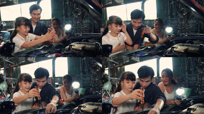 在车间汽车服务工作的快乐家庭和女儿实习生机械师