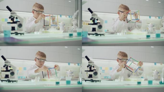 男孩在实验室进行科学实验。用肥皂泡液体研究表面张力