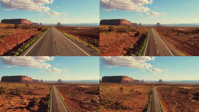 亚利桑那州纪念碑谷的无人驾驶飞机空中飞行视图。纳瓦霍族的红色干旱沙漠和空旷的道路