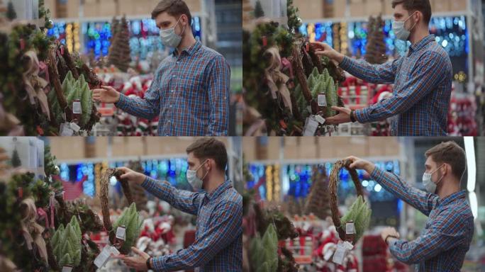 一名男子在珠宝店戴着防护面具，花环上放着圣诞树和家里的玩具。圣诞花环和装饰