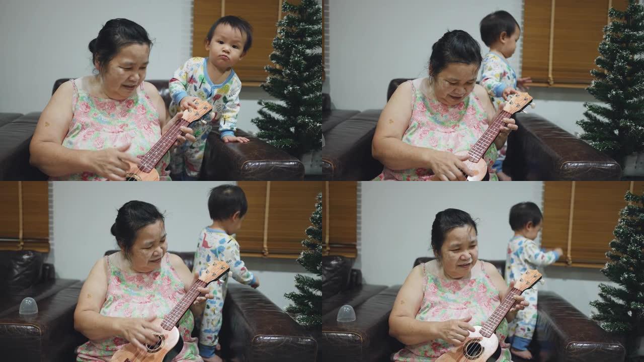 奶奶和男婴在客厅弹吉他。