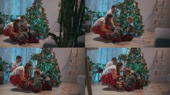 一家人一起装饰圣诞树。父亲是母亲，两个孩子一起放在圣诞树上。平安夜快乐的家庭