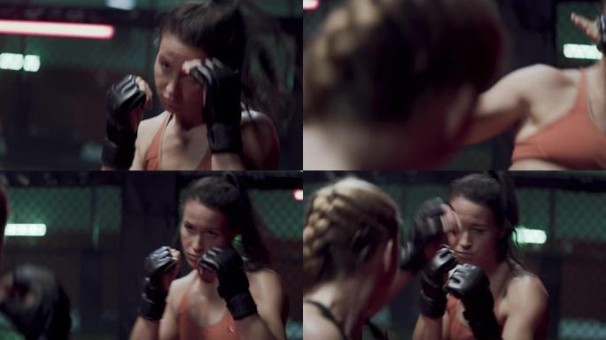 女子MMA战士训练。眼神交流和拳打