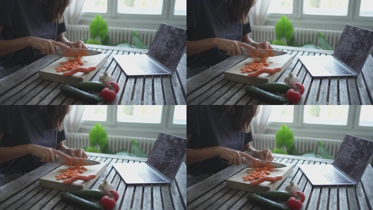 年轻女子在餐桌上切碎胡萝卜