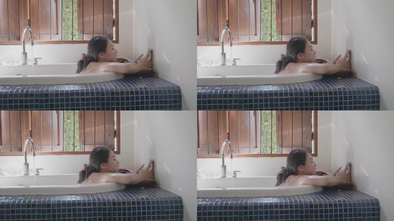 女人躺在浴缸上进行家庭水疗和放松