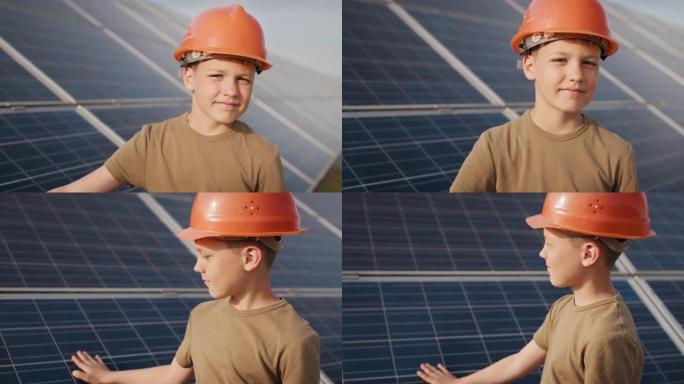 在太阳能发电厂戴着防护头盔的小男孩。儿童和绿色能量学的概念。清洁能源的孩子。在太阳能发电厂射击。生态