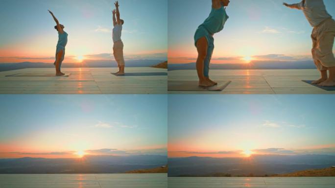 CS男女在日落时在山顶上同时做瑜伽和弯腰