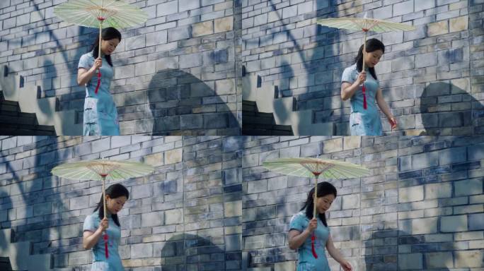 江南旗袍美女撑着油纸伞走在小巷中国文化