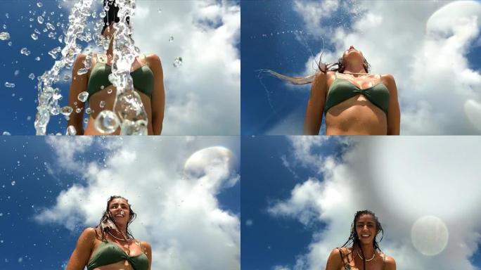 美丽的女人在海里泼水玩得开心。扔头发