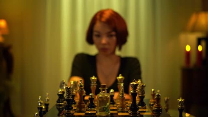 模糊的红发象棋棋手从坐在家里的棋盘上拿药瓶。沮丧的白人年轻女子服用药物计划表游戏策略。