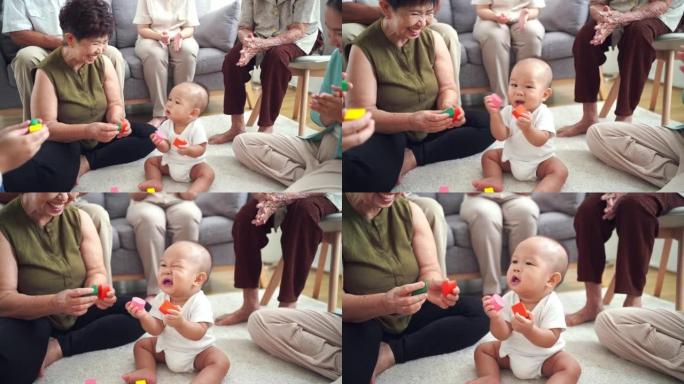 亚洲大家庭喜欢在家和新成员宝宝玩耍