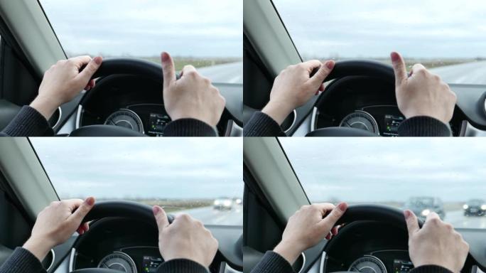 驾驶汽车时女性手在方向盘上的特写