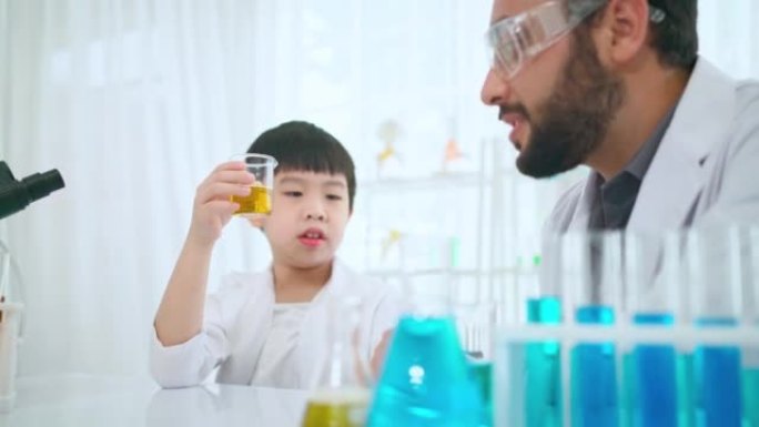 Young Asia kid doing experiment with foreigner tea