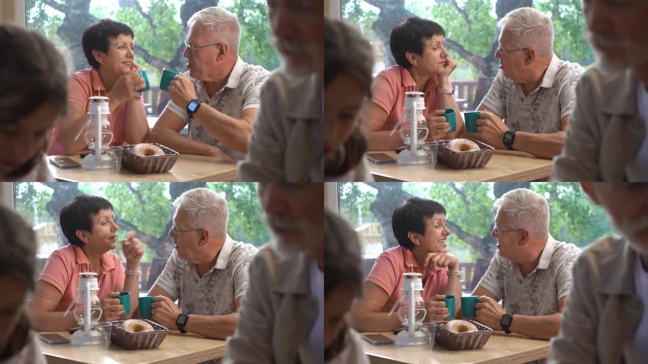 老年夫妇一边喝咖啡一边聊天，在餐厅放松