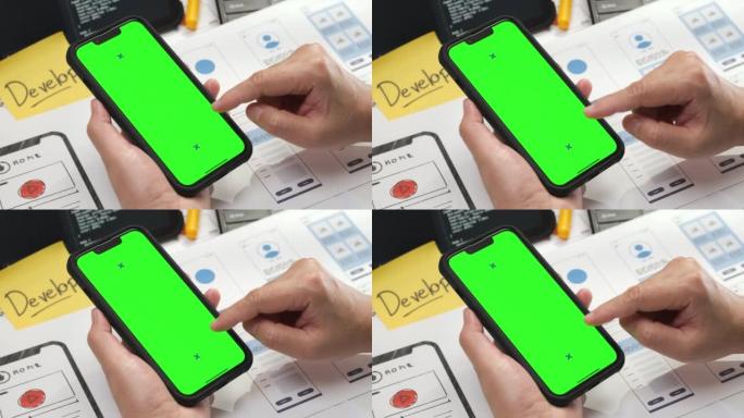 绿屏移动模型。女性ux ui开发人员在手机上测试移动原型应用程序的近距离编码