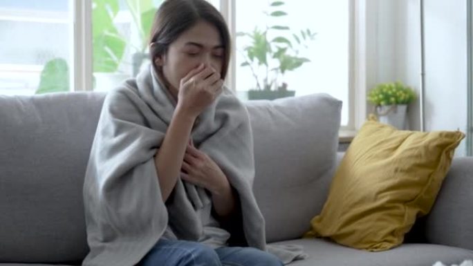 亚洲女性喉咙痛和发冷，她患了流感。