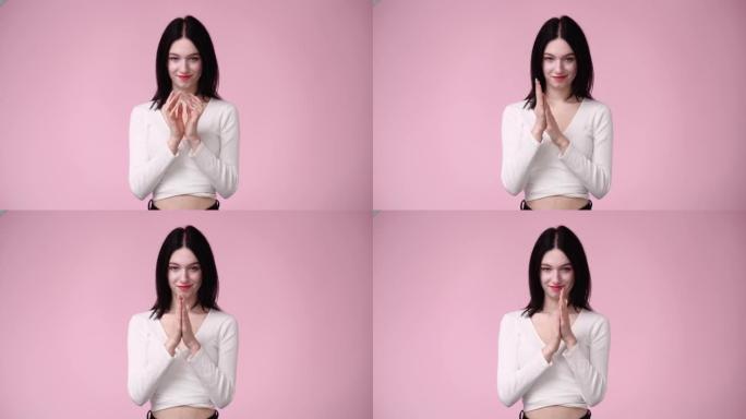 4k视频，女人在粉红色背景上揉手。