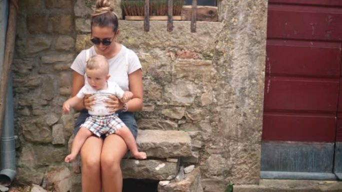 Smiling woman and her baby resting after a walk