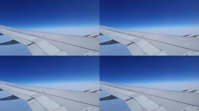 flight window view in air with bright blue sky at 