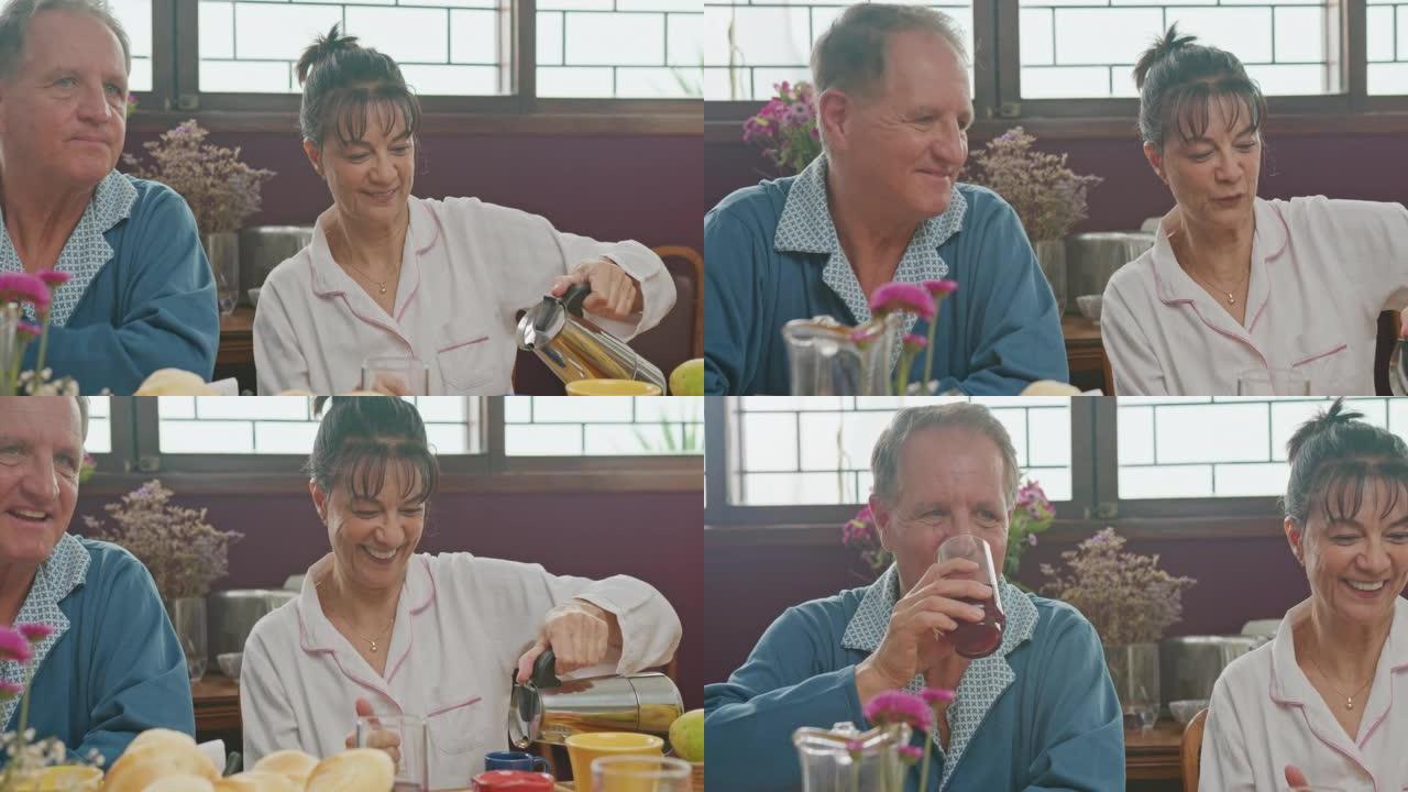 早餐桌上幸福的已婚老夫妇。已婚年龄的男人和女人服务和喝咖啡