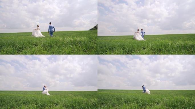 Newlyweds running together on the green field, rea