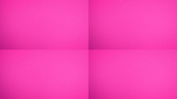 粉红色墙面的幻灯片。涂成粉红色表面的慢速微距。慢速垂直宏观多利。