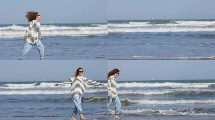 长卷发的年轻女子在沙滩上跳舞和玩耍。夏季概念。