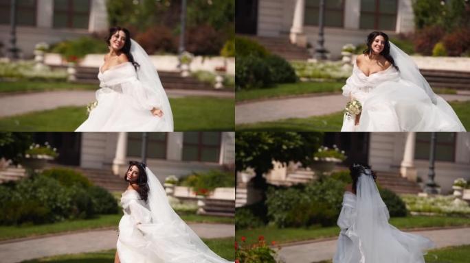 漂亮的新娘穿着长长的通风面纱，优雅的白色连衣裙在婚礼当天远离相机。顽皮迷人的女人逃跑转身，看着观众。