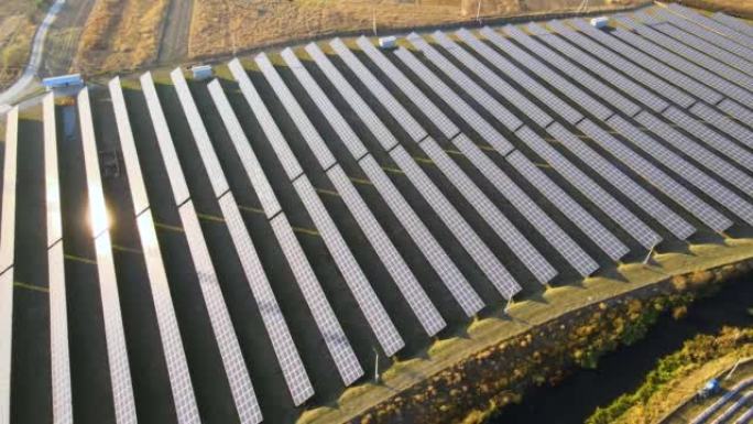 大型可持续发电厂的鸟瞰图，带有成排的太阳能光伏板，用于生产清洁的生态电能。零排放概念的可再生电力