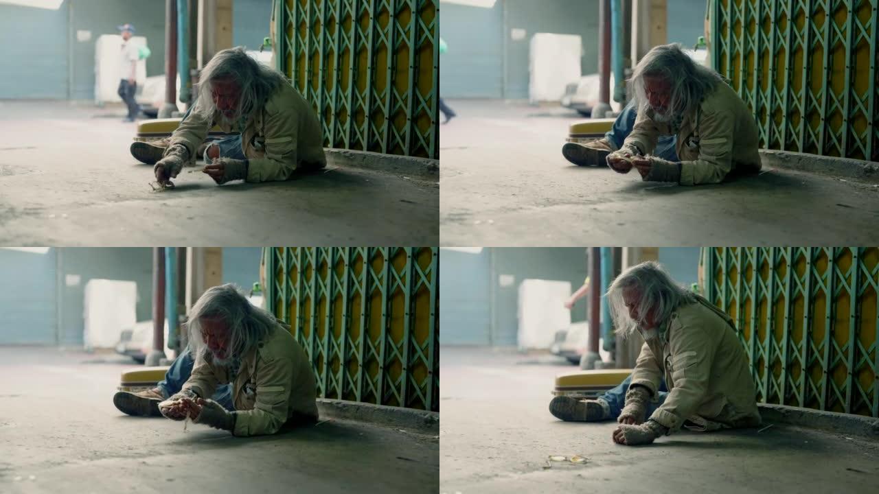 亚洲无家可归的老人心烦意乱，坐在人行道上没有钱，失业的悲惨老人试图修理他的破眼镜，社会经济问题人权利