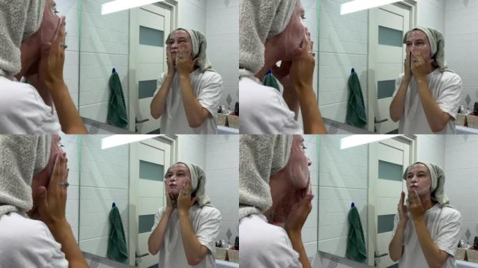年轻女子用洗面奶洗脸