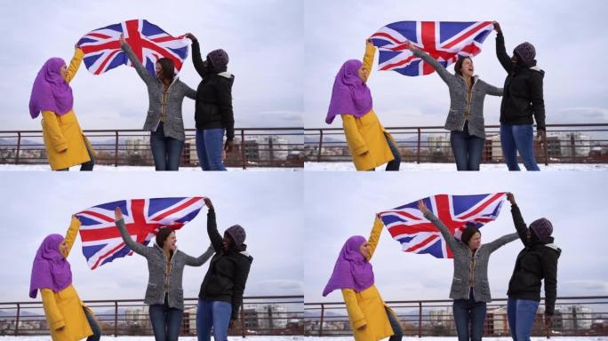 户外悬挂英国国旗的多民族女性朋友