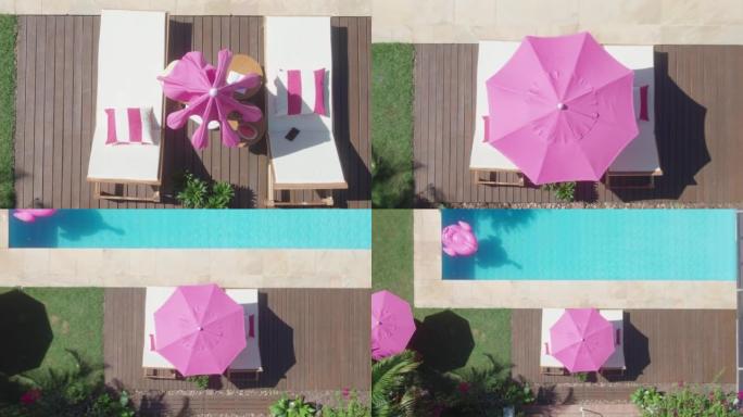空中自上而下的镜头显示后院的游泳池，空中无人机上升镜头，粉红色的雨伞，粉红色的火烈鸟浮标