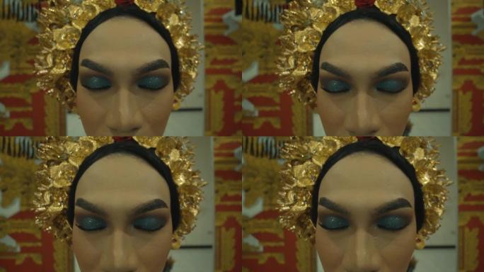 祈祷期间化妆和戴金冠的巴厘岛妇女的特写脸