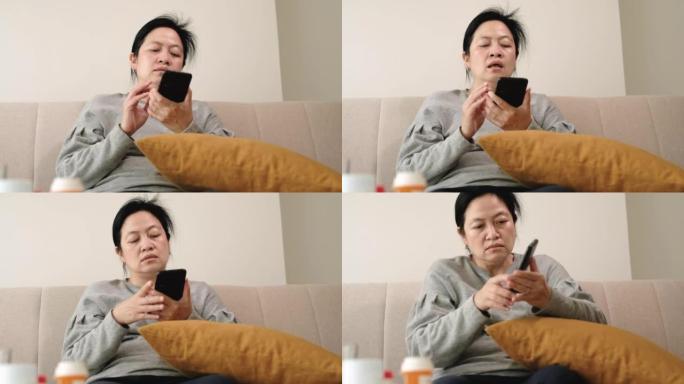 亚洲女性预约咨询医生在家中的手机应用程序。远程医疗