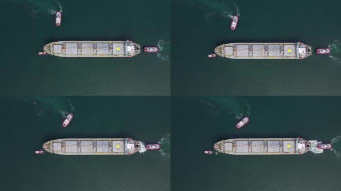 拖船辅助大型散货船的空中俯视图。由拖船护送的大船。