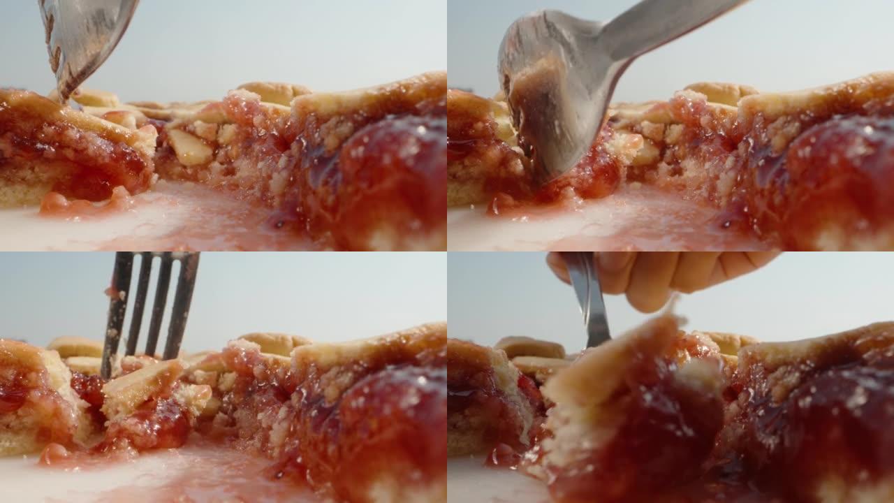 用樱桃果酱馅饼，我用叉子打碎一块，拿走。特写。
