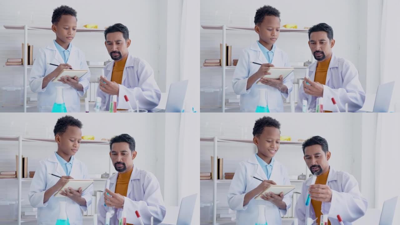 4K，大胡子的亚洲老师正在教混血男孩学生学习试管中的液体，并记下小学科学实验室里看到的东西。概念教育
