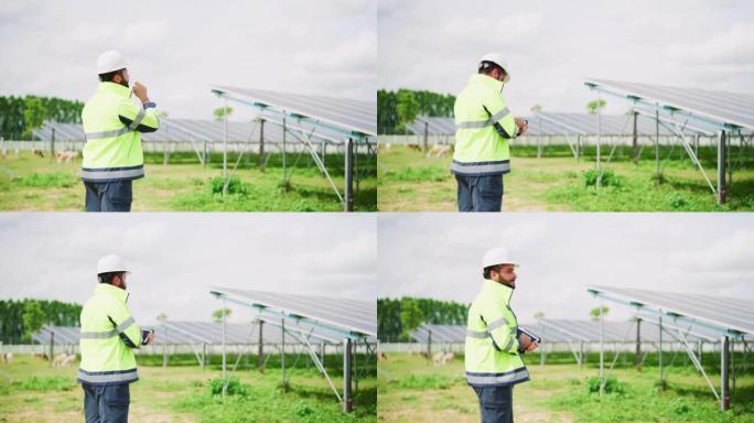 太阳能工程师使用平板电脑并检查太阳能电站中太阳能电池板模块的数据信息。太阳能电池板和光伏可持续技术。
