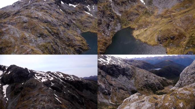 直升机镜头飞行，然后降落在新西兰Fiordlands国家公园的高峰之间。