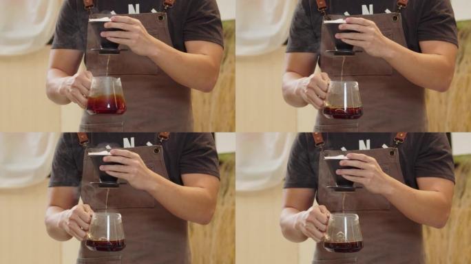 专业的咖啡师将水倒在过滤器中的咖啡渣上。