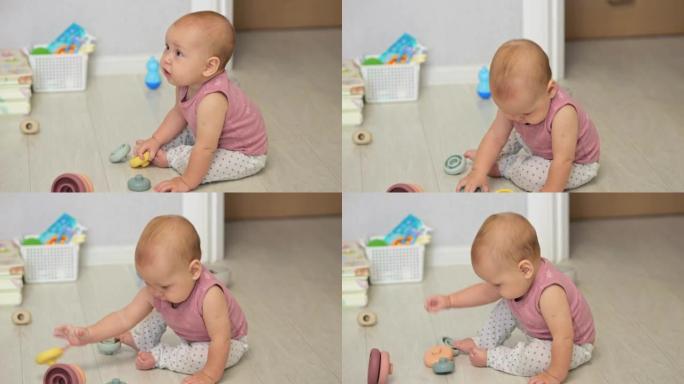 女婴喜欢在地板上玩玩具探索世界