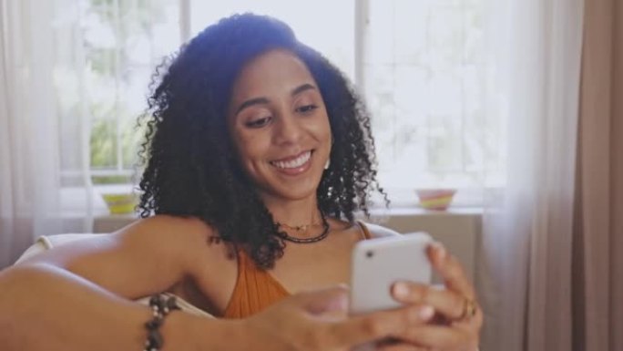 Smiling young woman on her phone texting a funny m