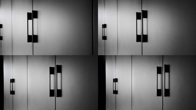 现代室内简约黑色衣柜。门细节。极简主义黑色门