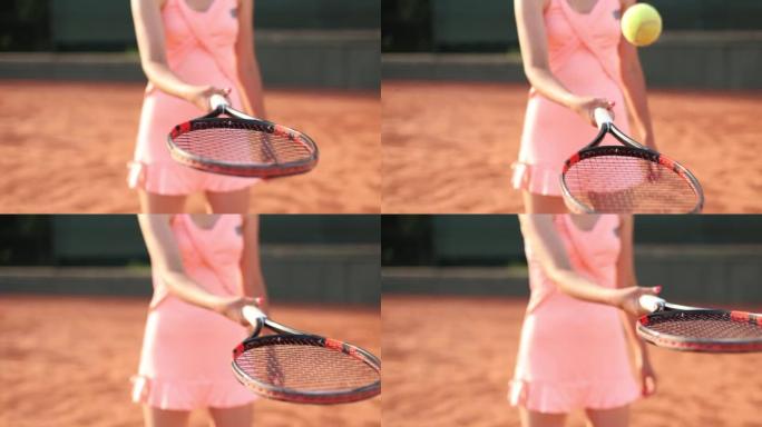 专业装备的女网球运动员用球拍用力敲打网球。